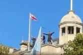 Tommy Robinson supporters scale building and chant his name as London protests turn violent