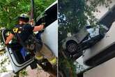 Porsche left dangling off high-rise car park as woman only saved thanks to a tree