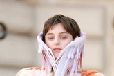 The Crown's Emma Corrin goes topless in daring bird-themed outfit at Paris Fashion Week
