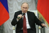 Putin downs more champagne as he gives award to nuclear boss who compared NATO to Hitler