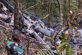 Mystery as rescuers find helicopter wreckage in jungle but recover only one of eight bodies