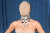 Kim Kardashian attends gala in 'faceless' nude outfit with lipreader explaining outburst