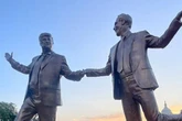 Orange man baby reacts furiously to giant statue of him holding hands with Epstein