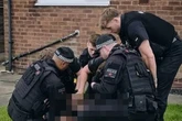 Moment 'man with brick' is bundled by cops after falling from window in school incident