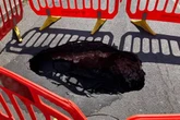 Huge sinkhole opens up and forces road closure as locals say "it's lucky nobody was hurt"