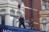 Moment toddler hangs from ledge above East London high street before heroic bystander catches her