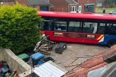 Family's lucky escape after bus carrying passengers smashes through garden wall