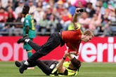 World Cup match stopped as three protesters wrestled and removed from pitch