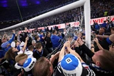 Huge pitch invasion sees 25 fans rushed to hospital as one suffers life-threatening injuries