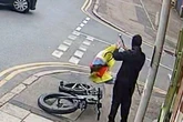 Moment yob rips down beauty salon's Pride flag in broad daylight as cars pass by