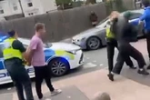 Moment man punches police officer in face as she tries to make arrest in Birmingham