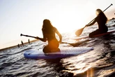 Woman left in floods of tears as she spots unusual sight in water while paddleboarding