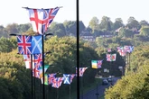 Group use cherry picker to erect over 40 flags on lampposts along entire Birmingham street