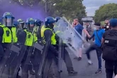 Protesters clash with police outside hotel housing asylum seekers
