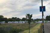 30 caravans surround city park's basketball court with camp yards from primary school