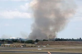 Huge plume of smoke seen from Birmingham Airport as fire crews fight woodland blaze