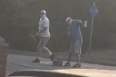 Men in St George's masks filmed painting England flag on Midland roundabout