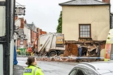 Man dies after bin lorry crashes into building