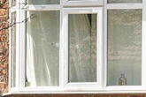 Shock pictures show bullet holes in glass where woman seriously hurt in shooting