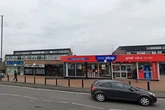 Man arrested after shop staff threatened during knifepoint robbery