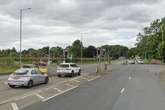 Ambulance on blue lights involved in crash with van at busy Midlands junction