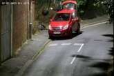 Hooded fly-tipper caught on camera chucking rubbish bags from boot of car