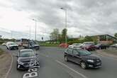 Major road closed in both directions after lorry hits building