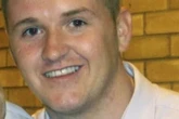 Dad shot in head after opening door to his home