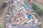 Full list of charges against man and company after 20m pile of waste 'dumped in road'