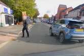 Moment dangerous driver runs red light at crossing narrowly avoiding pedestrian