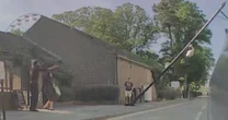 Lamppost crashes down across busy road narrowly missing astonished Tesla driverCCTV footage