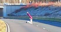 Woman spotted doing yoga in middle of major road shut due to severe flooding