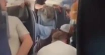 Mid-air horror as passengers tackle man trying to open plane door before duct-taping his legsAmerican Airlines