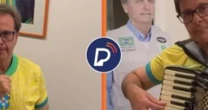 Gilson Machado toca sanfona e canta Hino Nacional ao lado de imagem de Bolsonaro