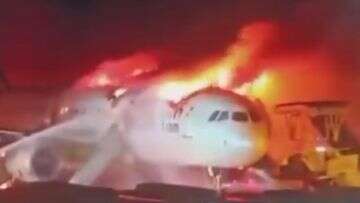 Passengers and crew flee burning South Korean plane on escape slides