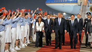 World watches as Trump touches down in Beijing