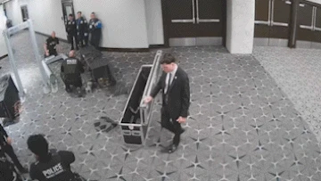 Surveillance footage shows gunman charging through officers