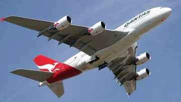 Woman dies mid-air on Qantas flight