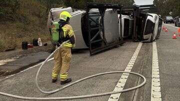 Truck carrying six cars rolls after crash south of Sydney