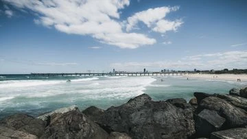 Three rescued after boat capsizes off Gold Coast beach