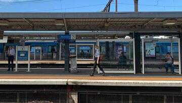 Woman in hospital after being pushed onto Melbourne train tracks by stranger