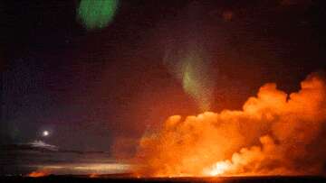 Northern lights dance above erupting volcano