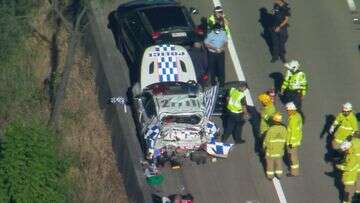 Three injured after police car hit by ute on Gold Coast highway