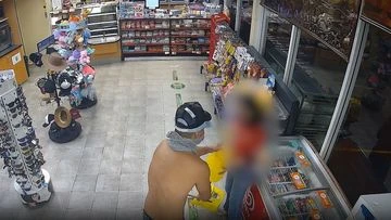 Shirtless armed robber caught on CCTV holding up service station