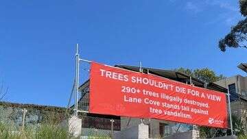 Council installs banner to block view after hundreds of trees vandalised