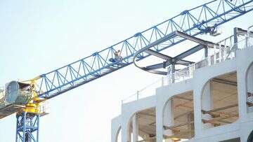 Man scales crane at construction site in Melbourne