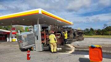 Truck rolls metres from petrol bowsers off major NSW highway