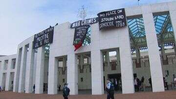 Protesters unfurl banners atop Parliament House