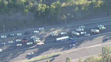 Driver and passenger trapped after crash between bus and car