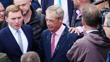 Milkshake thrown at British politician Nigel Farage as he leaves pub
